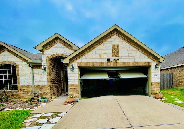 french country home featuring concrete driveway, brick siding, and an attached garage