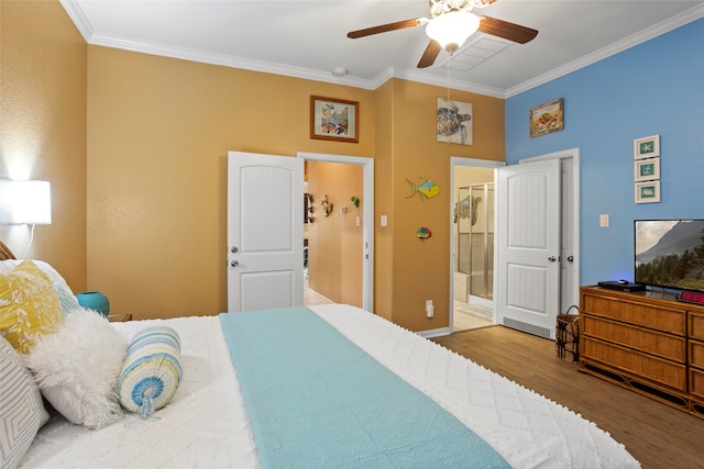 bedroom featuring a ceiling fan, ornamental molding, wood finished floors, and ensuite bathroom