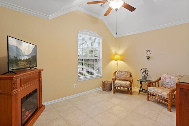 living area with light tile patterned floors, baseboards, a glass covered fireplace, ornamental molding, and vaulted ceiling