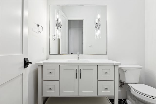 bathroom with toilet and vanity