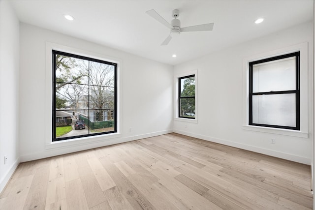 spare room with light hardwood / wood-style floors and ceiling fan