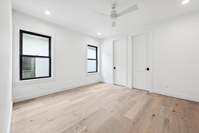 spare room with ceiling fan and light hardwood / wood-style floors