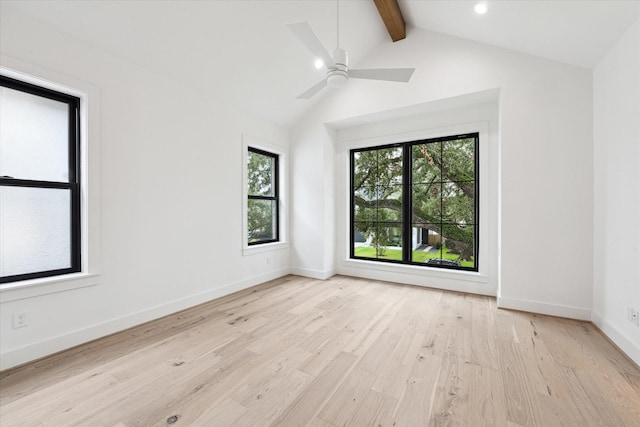 spare room featuring light wood-type flooring, ceiling fan, and lofted ceiling with beams