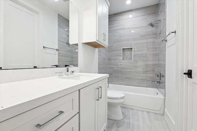 full bathroom with tiled shower / bath combo, vanity, and toilet