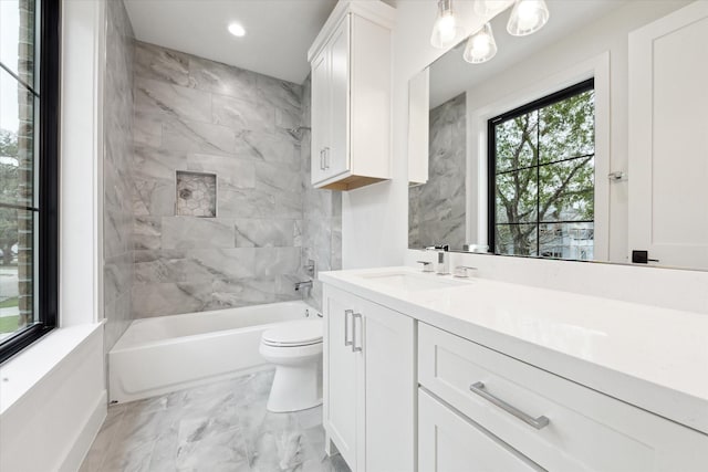 full bathroom with toilet, vanity, and tiled shower / bath combo