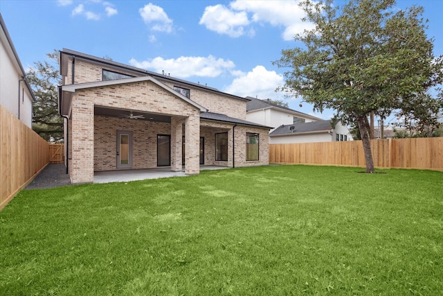 back of house with a yard, ceiling fan, and a patio area