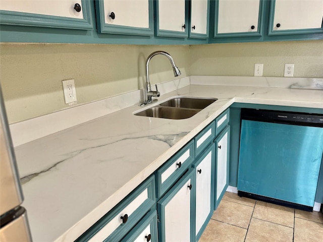 kitchen with dishwashing machine, sink, light stone countertops, and light tile patterned floors