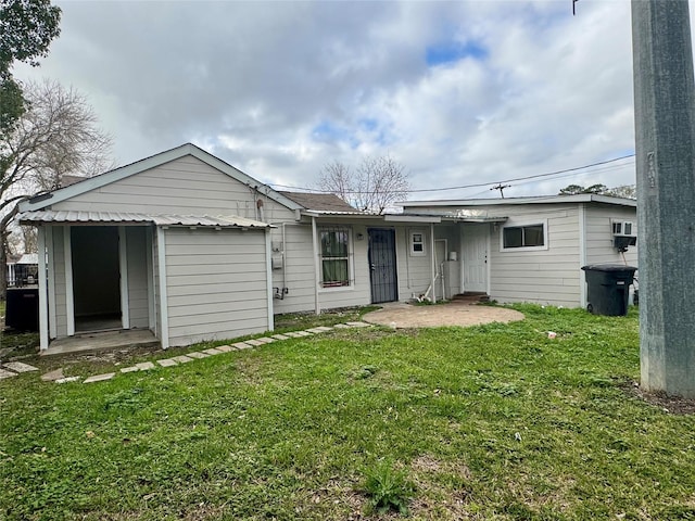 rear view of house with a garage and a lawn