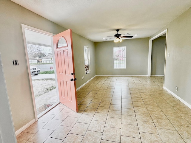 entrance foyer featuring ceiling fan and light tile patterned floors