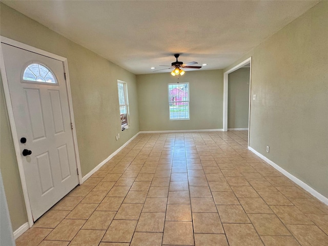 tiled foyer entrance with ceiling fan