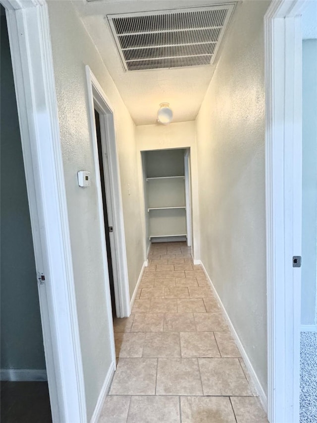 corridor with light tile patterned flooring