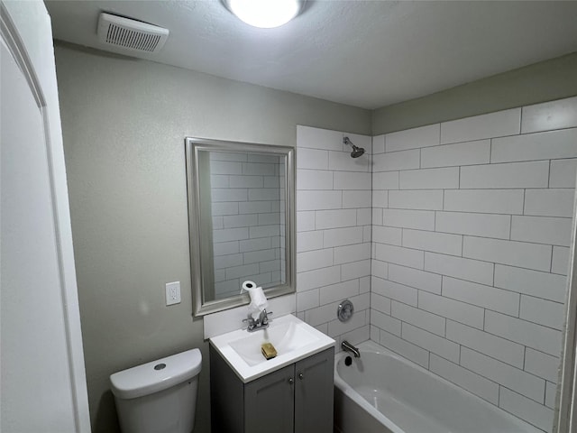 full bathroom with vanity, toilet, and tiled shower / bath combo