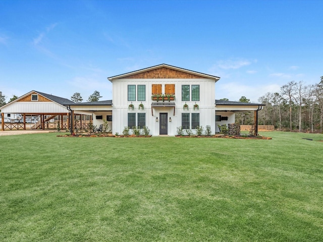 rear view of property featuring a lawn