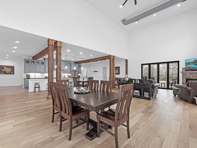 192 B Fm 1097, New Waverly, TX 77358 - dining area with light wood-style flooring, a high ceiling, baseboards, and beamed ceiling