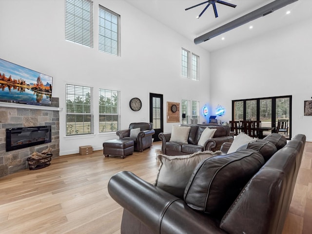 192 B Fm 1097, New Waverly, TX 77358 - living room featuring a towering ceiling, wood finished floors, a fireplace, plenty of natural light, and recessed lighting
