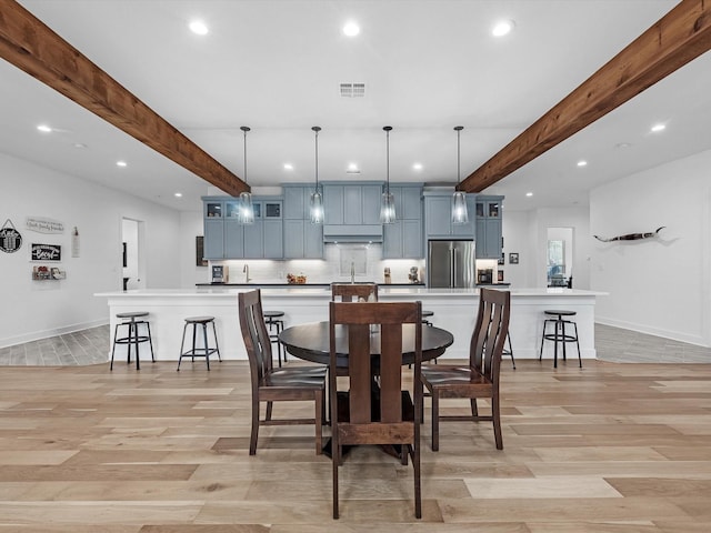 192 B Fm 1097, New Waverly, TX 77358 - dining room featuring recessed lighting, beam ceiling, light wood-style flooring, and baseboards