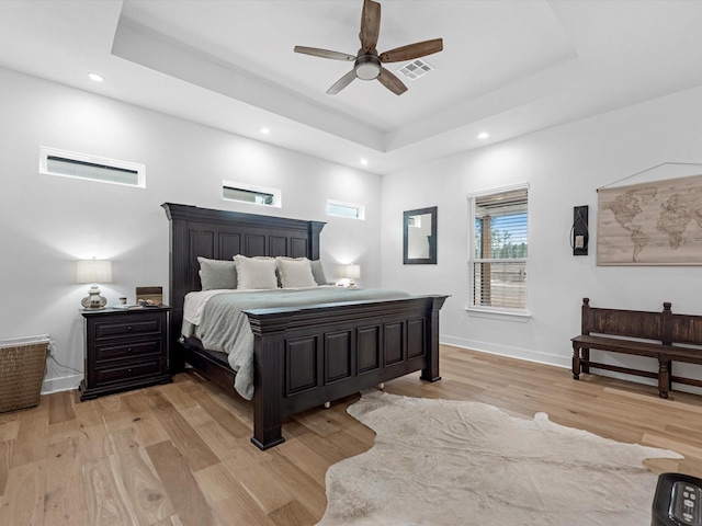 192 B Fm 1097, New Waverly, TX 77358 - bedroom featuring a tray ceiling, light wood-style flooring, recessed lighting, baseboards, and ceiling fan