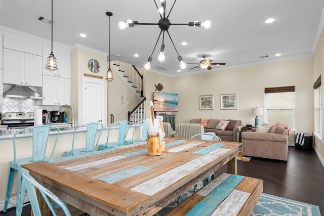 11446 Sea Butterfly, Galveston, TX 77554 - dining room featuring a ceiling fan, stairs, ornamental molding, recessed lighting, and dark wood-type flooring