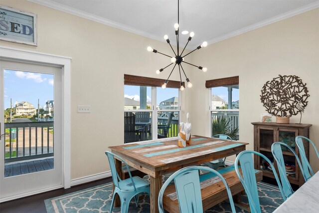 11446 Sea Butterfly, Galveston, TX 77554 - dining space with a chandelier, crown molding, dark wood-style flooring, and baseboards