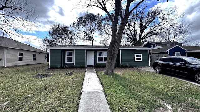 single story home featuring a front yard