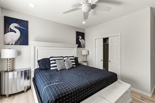 bedroom featuring ceiling fan, a closet, and light hardwood / wood-style flooring