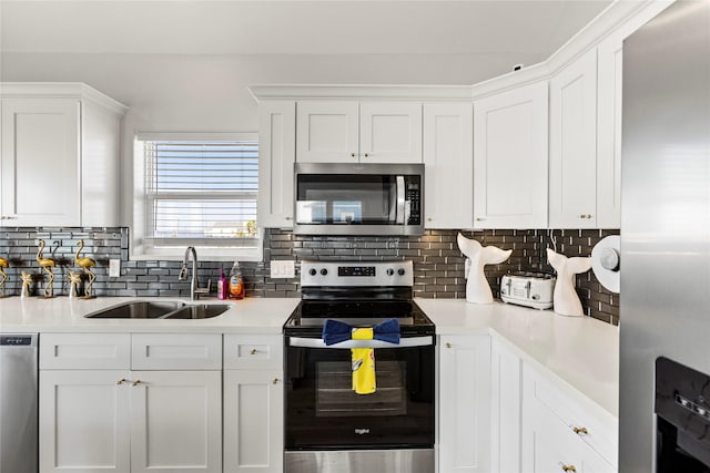 kitchen with white cabinetry, appliances with stainless steel finishes, sink, and decorative backsplash