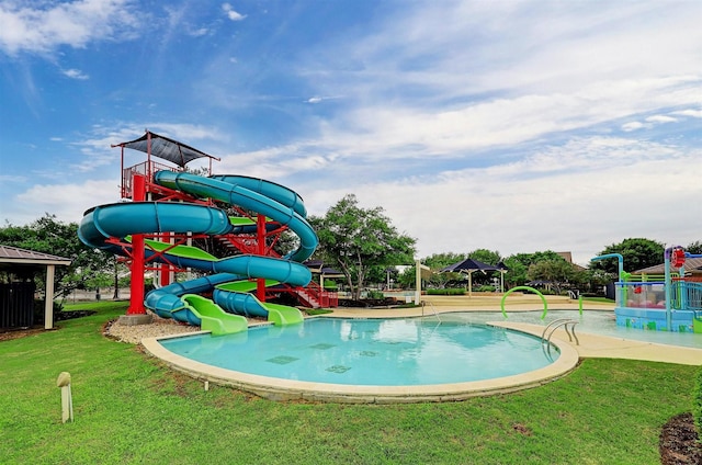 view of pool with a playground and a lawn