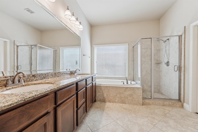 bathroom with tile patterned floors, vanity, and separate shower and tub