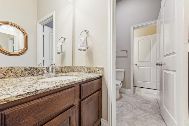 bathroom with vanity, tile patterned flooring, and toilet