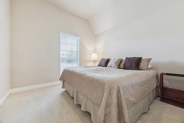 bedroom featuring lofted ceiling and light colored carpet