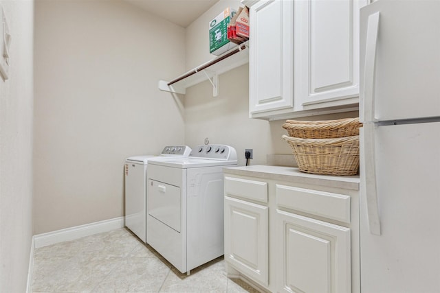 washroom with cabinets, light tile patterned floors, and independent washer and dryer