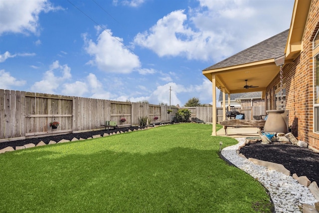 view of yard with a patio and ceiling fan