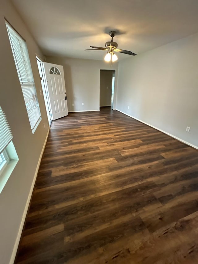 spare room with dark hardwood / wood-style flooring and ceiling fan