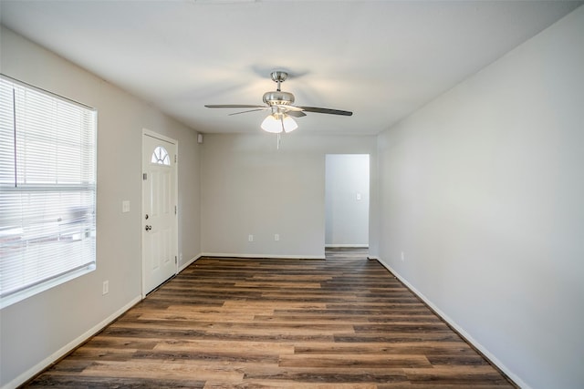 empty room featuring ceiling fan and dark hardwood / wood-style flooring