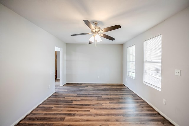 empty room featuring ceiling fan and dark hardwood / wood-style flooring