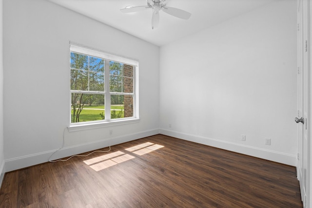 spare room featuring dark wood-type flooring and ceiling fan