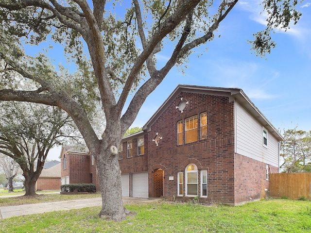 view of front of home featuring a garage, brick siding, fence, driveway, and a front yard