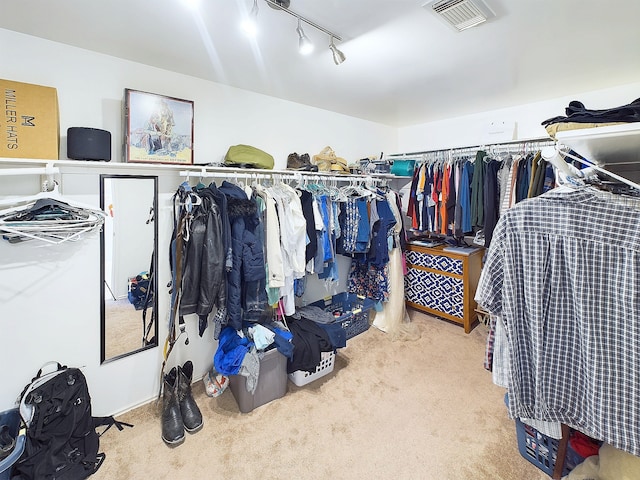 walk in closet with visible vents and light carpet