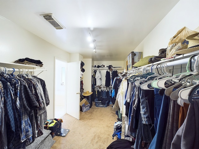 walk in closet featuring visible vents and carpet flooring