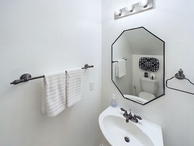 bathroom featuring toilet and a sink