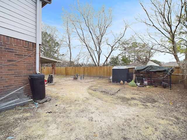 view of yard featuring fence and an outdoor structure