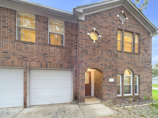 view of front of property featuring brick siding and an attached garage