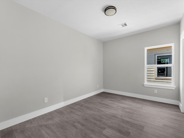 unfurnished room with hardwood / wood-style flooring