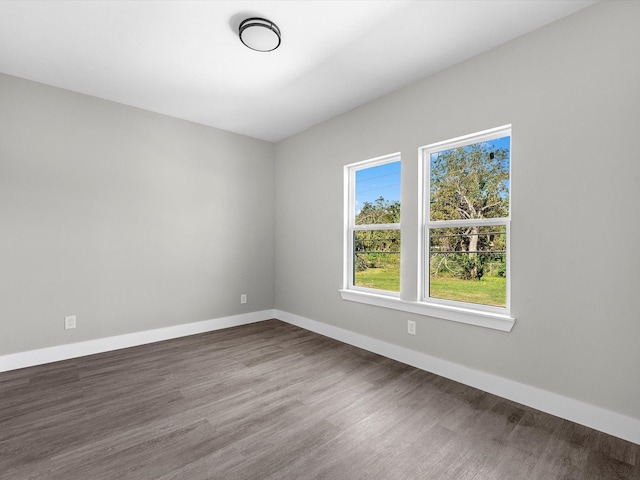 spare room with dark hardwood / wood-style flooring