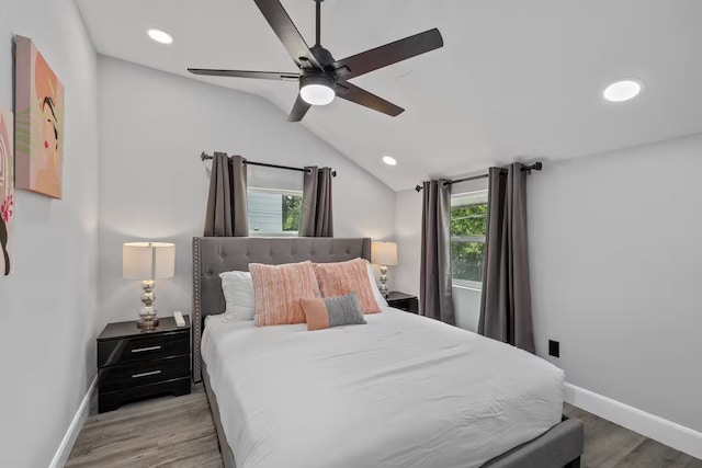 bedroom featuring lofted ceiling, light hardwood / wood-style floors, and ceiling fan