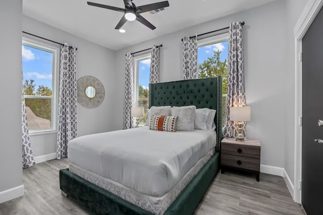 bedroom with ceiling fan and wood-type flooring