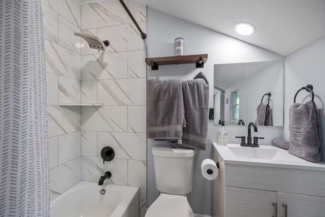 full bathroom featuring lofted ceiling, vanity, tiled shower / bath combo, and toilet