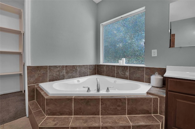 bathroom with a relaxing tiled tub and vanity