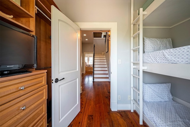 bedroom with dark hardwood / wood-style flooring