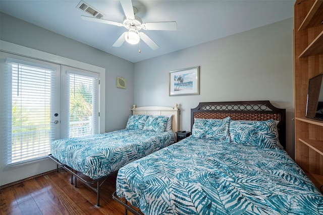 bedroom featuring multiple windows, wood-type flooring, access to exterior, and ceiling fan